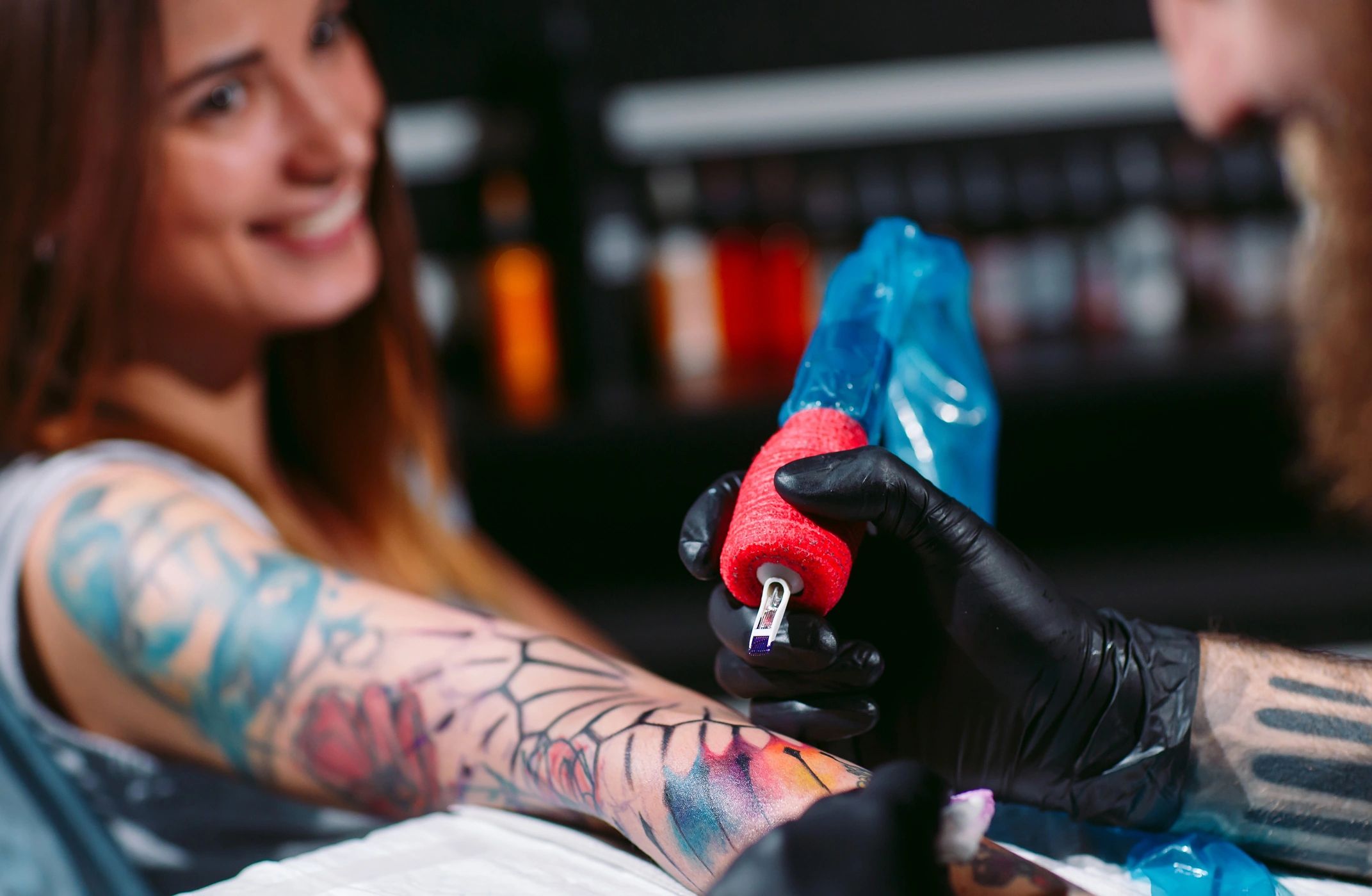 Professional tattoo artist makes a tattoo on a client.